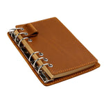 Taccuino vintage in vera pelle con fogli sfusi staccabili, ideale come diario di viaggio.