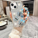 Custodia per telefono in TPU e resina epossidica con farfalla 3D glitterata e bracciale a catena, For iPhone 15 Pro Max, For iPhone 15 Pro, For iPhone 15 Plus, For iPhone 15, For iPhone 14 Plus, For iPhone 14, For iPhone 14 Pro, For iPhone 14 Pro Max