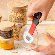 Strumento di pulizia 2 in 1 con raschietto e adesivo, ideale per la pulizia domestica.