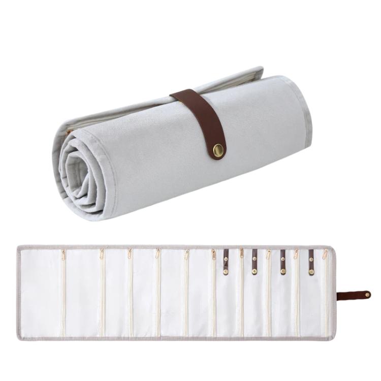 Borsa organizer arrotolabile in velluto per gioielli, con scomparti multipli per collane, bracciali e accessori in oro.